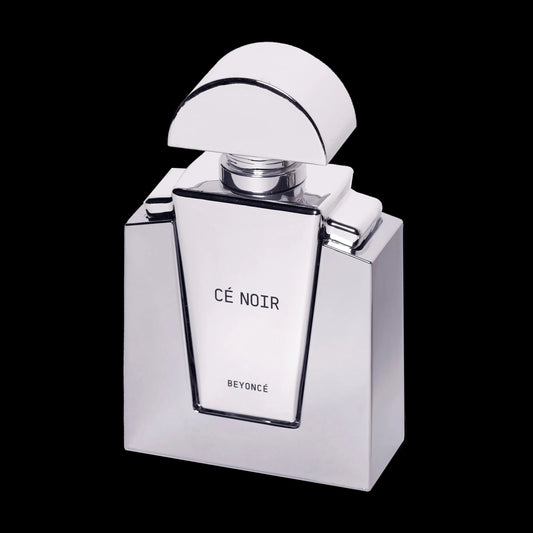 Cé Noir silver perfume bottle shown open against black, label facing forward