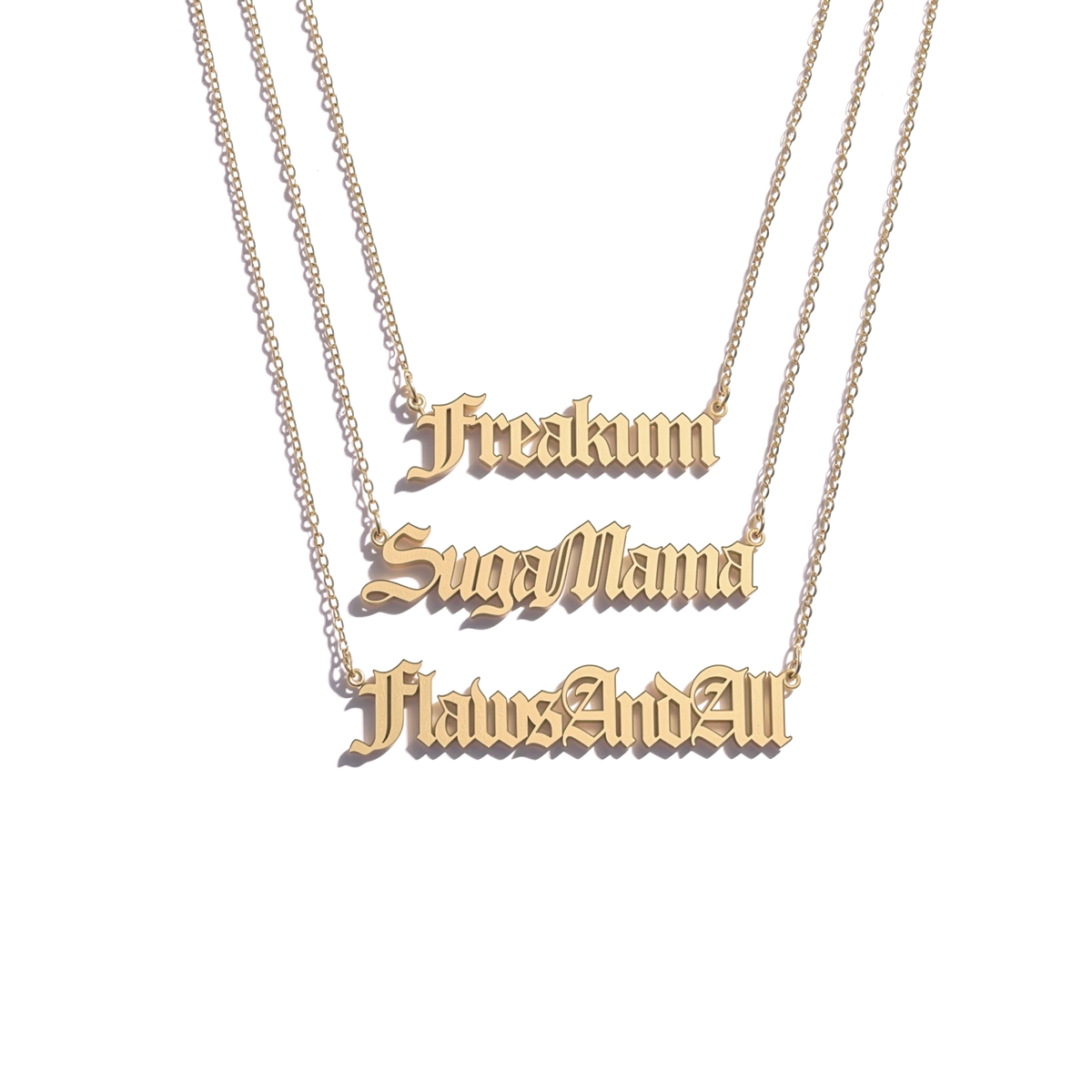 Beyoncé B'DAY Trackplates Side A, three gold nameplate necklaces reading Freakum, SugaMama and FlawsAndAll