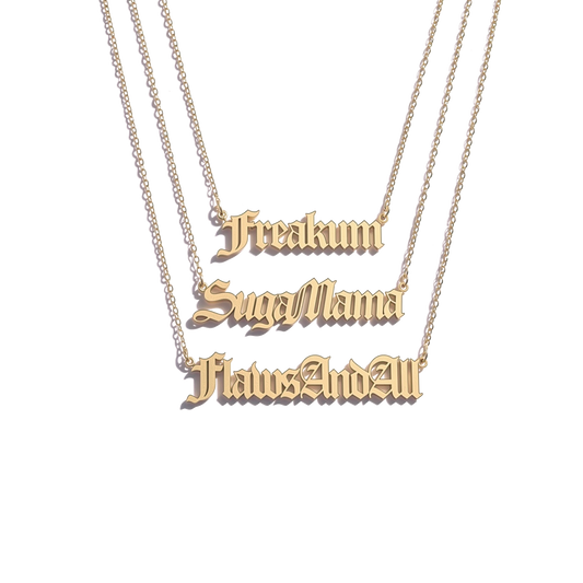 Beyoncé B'DAY Trackplates Side A, three gold nameplate necklaces reading Freakum, SugaMama and FlawsAndAll